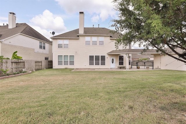 back of property featuring a lawn and a patio