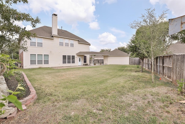 back of house with a yard