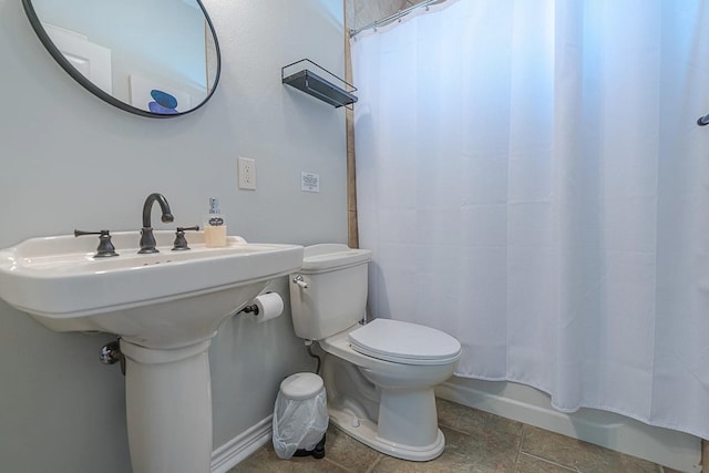 bathroom with tile patterned flooring and toilet