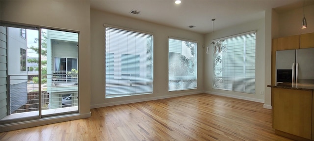 interior space featuring light hardwood / wood-style flooring and an inviting chandelier