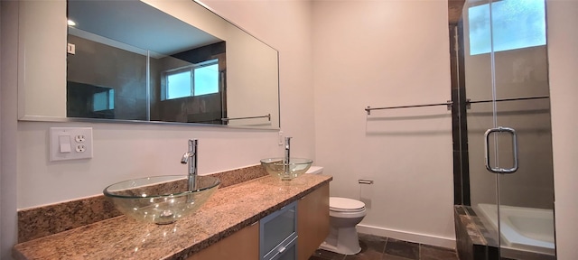 bathroom featuring vanity, toilet, and walk in shower