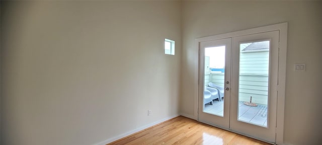 entryway featuring plenty of natural light, french doors, and light hardwood / wood-style flooring