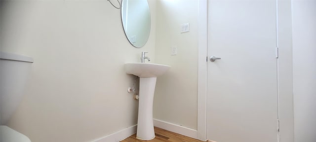 bathroom with hardwood / wood-style flooring