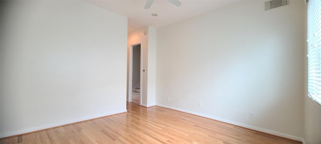 empty room featuring ceiling fan and light hardwood / wood-style flooring