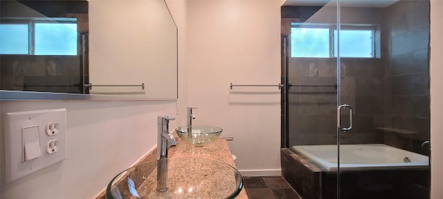 bathroom featuring tile patterned flooring, a healthy amount of sunlight, and sink