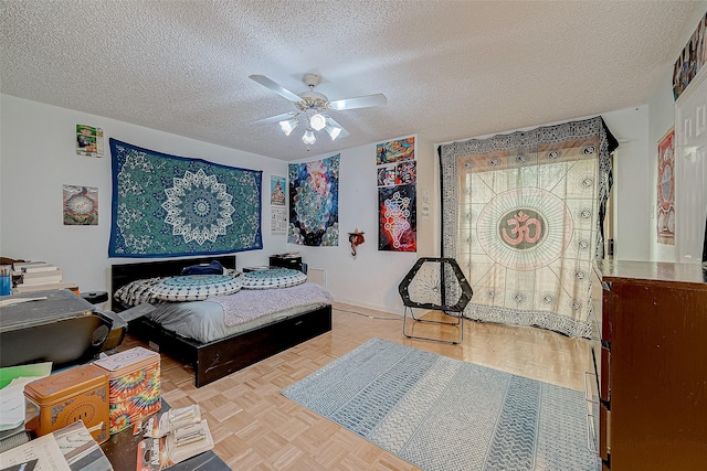 bedroom featuring a textured ceiling, ceiling fan, and light parquet flooring