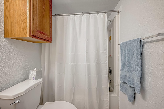 bathroom with shower / bath combination with curtain and toilet