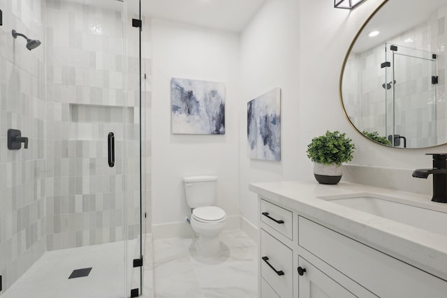 bathroom featuring an enclosed shower, vanity, and toilet