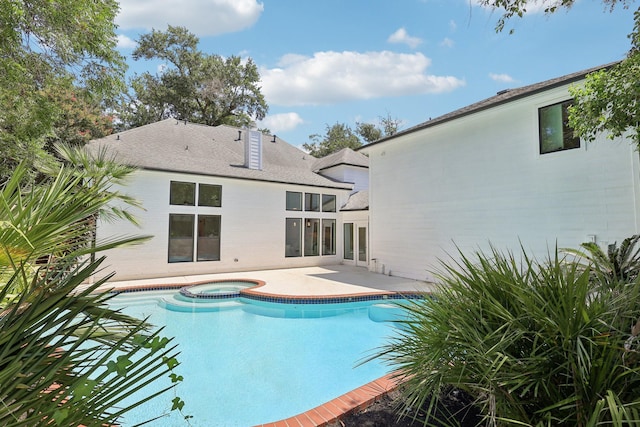 view of swimming pool with an in ground hot tub and a patio area