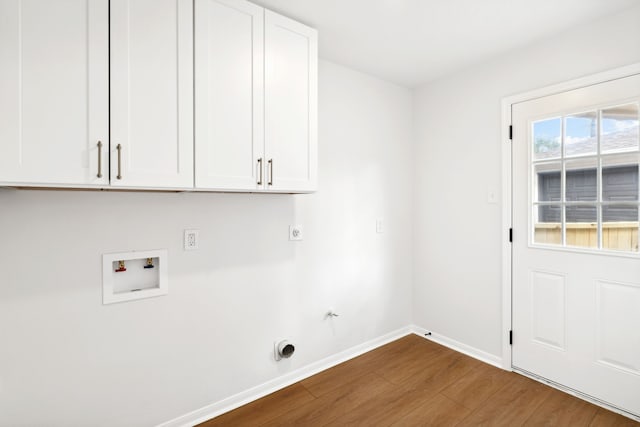 laundry area featuring cabinets, washer hookup, gas dryer hookup, electric dryer hookup, and wood-type flooring