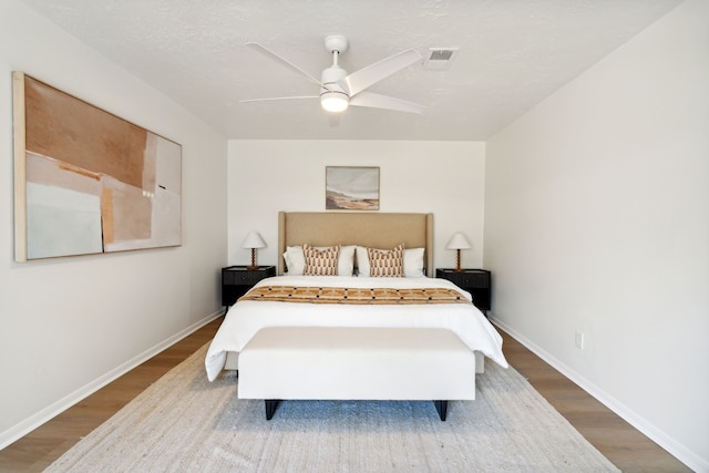 bedroom with wood-type flooring and ceiling fan