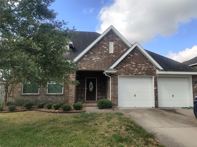 view of front of home with a front lawn and a garage