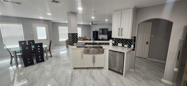 kitchen featuring dishwasher, white cabinetry, kitchen peninsula, and sink