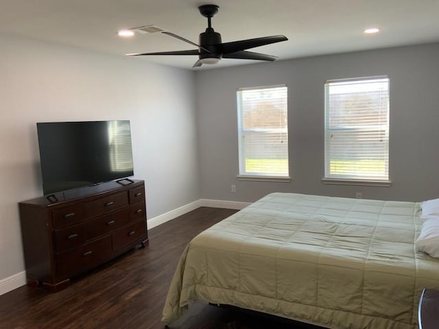 bedroom with dark hardwood / wood-style floors and ceiling fan