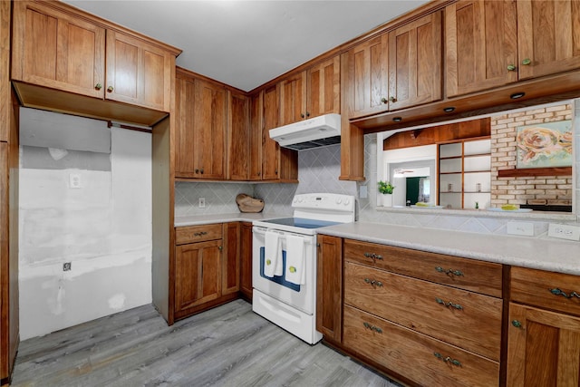 kitchen with backsplash, light hardwood / wood-style flooring, and white electric stove