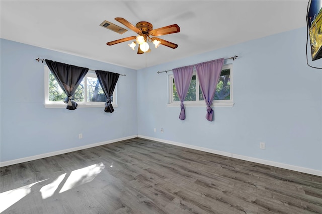 spare room with wood-type flooring and ceiling fan