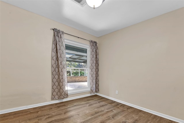 empty room with wood-type flooring