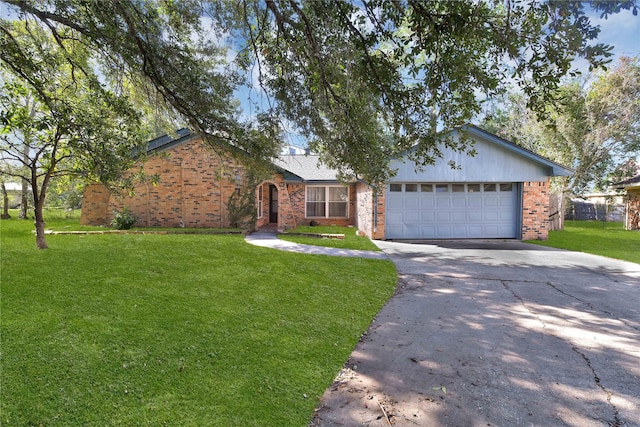 single story home with an attached garage, concrete driveway, brick siding, and a front yard