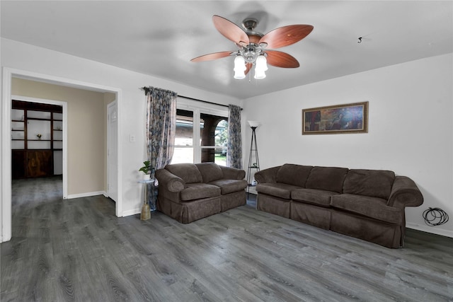 living room with ceiling fan and dark hardwood / wood-style flooring