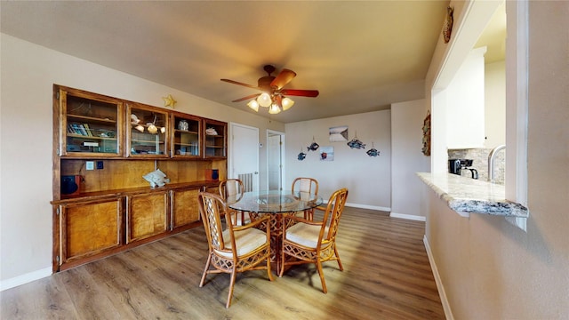 dining room featuring hardwood / wood-style floors and ceiling fan