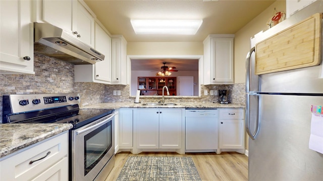 kitchen with ceiling fan, sink, tasteful backsplash, white cabinets, and appliances with stainless steel finishes