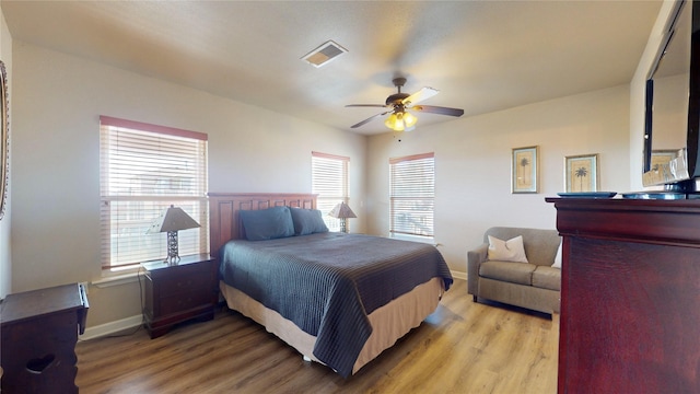 bedroom with ceiling fan and light hardwood / wood-style floors