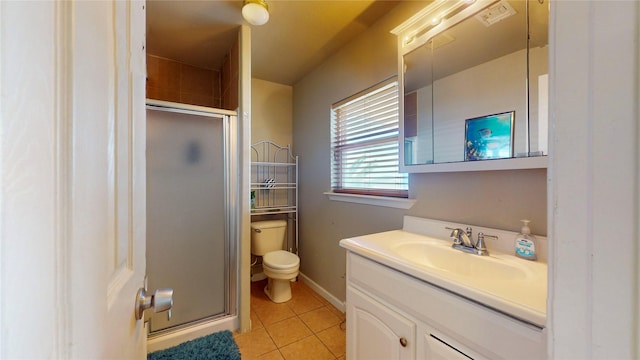 bathroom featuring tile patterned floors, a shower with door, vanity, and toilet