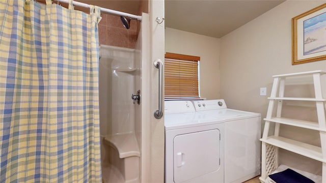 clothes washing area with washing machine and dryer