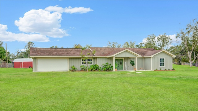 ranch-style home featuring a front lawn and a garage