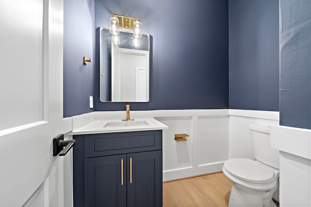 bathroom featuring hardwood / wood-style flooring, vanity, and toilet