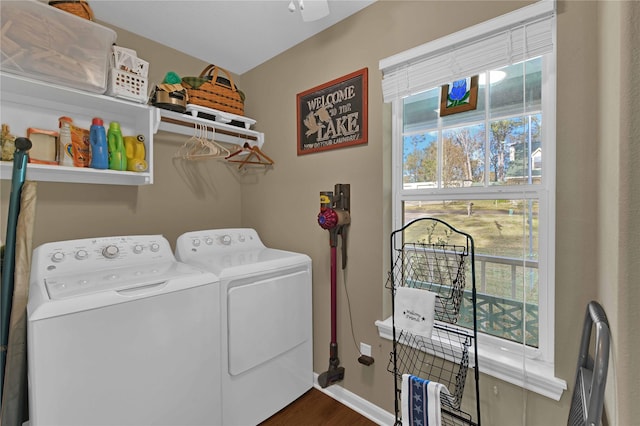 clothes washing area featuring dark hardwood / wood-style flooring, separate washer and dryer, and a wealth of natural light