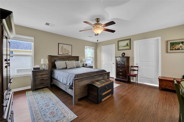 bedroom with ceiling fan and dark wood-type flooring