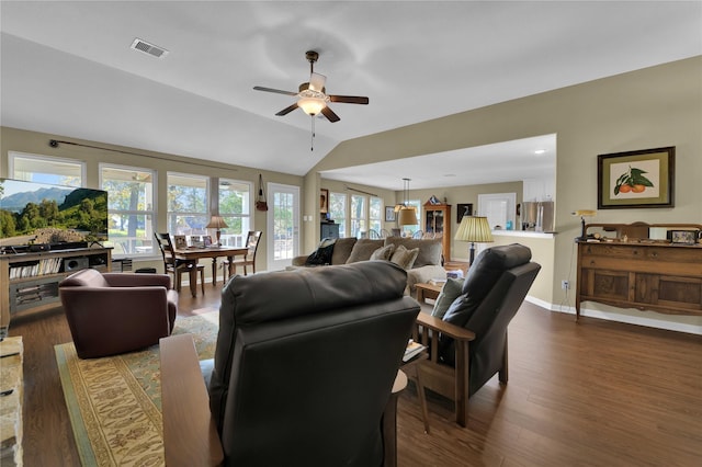 living room featuring dark hardwood / wood-style flooring, vaulted ceiling, and ceiling fan