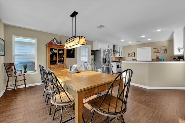 dining space with dark wood-type flooring