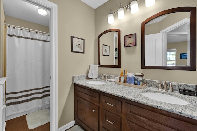 bathroom with vanity and hardwood / wood-style flooring