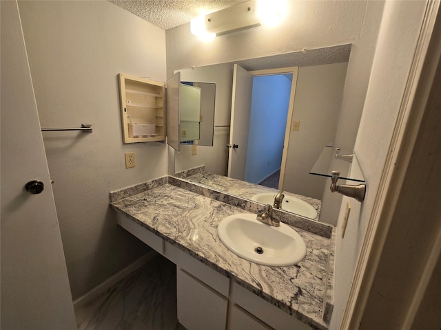 bathroom featuring vanity and a textured ceiling