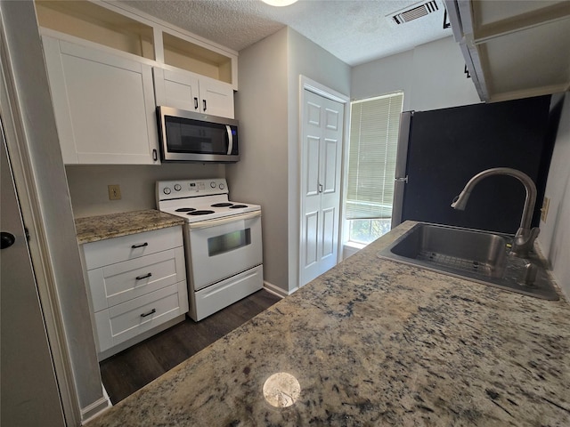 kitchen with light stone counters, sink, white cabinets, and white electric range oven