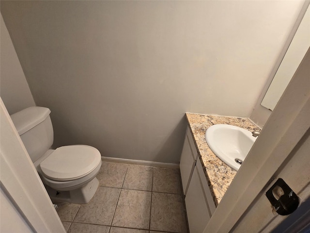 bathroom with tile patterned flooring, vanity, and toilet