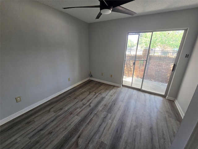 empty room with dark hardwood / wood-style floors and ceiling fan