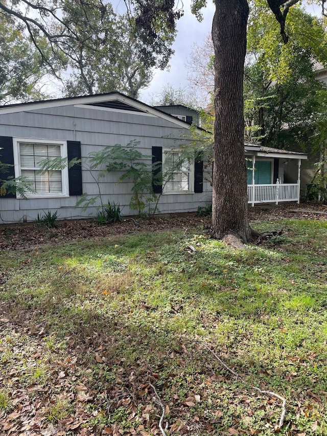 view of side of home with a porch