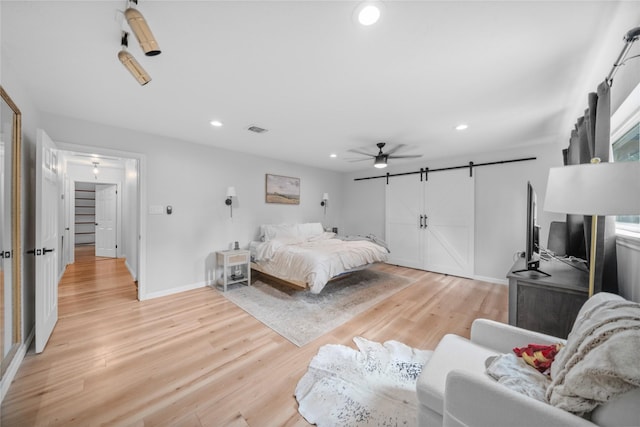 bedroom with ceiling fan and light hardwood / wood-style flooring