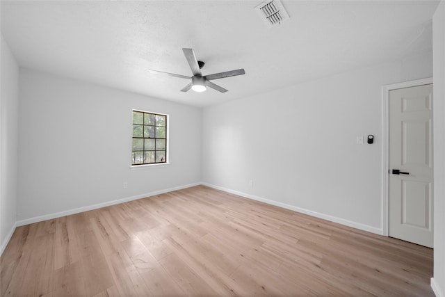 spare room featuring light hardwood / wood-style floors and ceiling fan