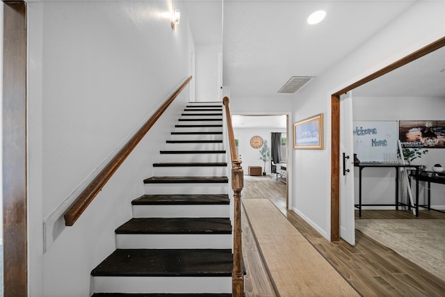 stairs with wood-type flooring