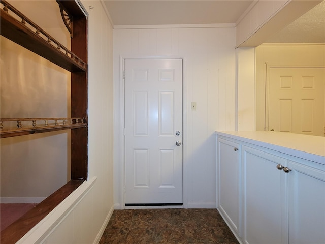 doorway featuring ornamental molding and wooden walls