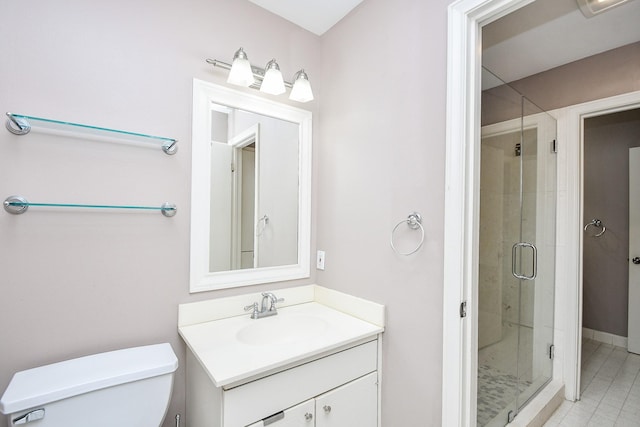 bathroom featuring vanity, toilet, and a shower with shower door