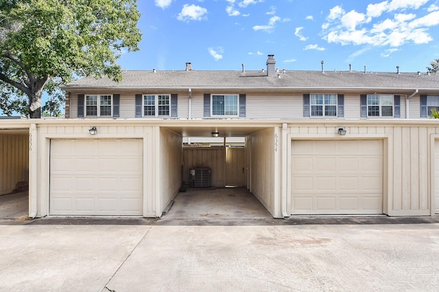 view of front of property with central AC unit and a garage