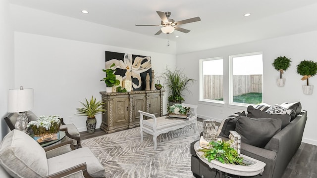 living room featuring hardwood / wood-style floors and ceiling fan