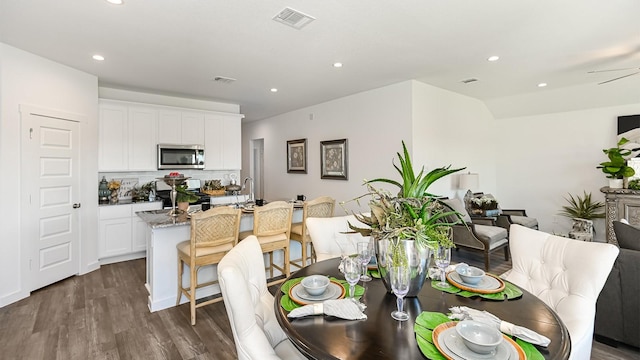 dining room with dark hardwood / wood-style floors and ceiling fan