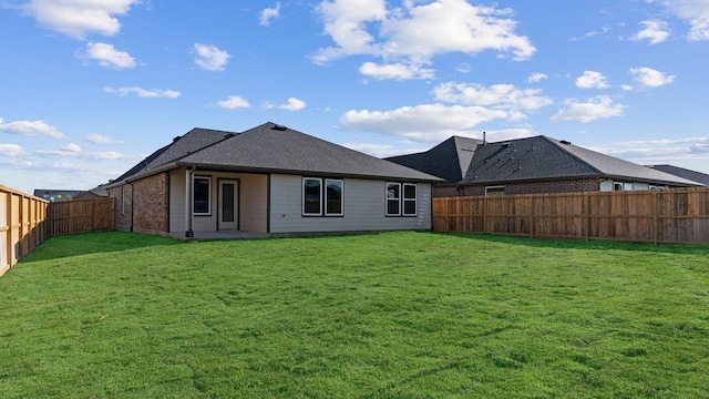 rear view of house with a yard