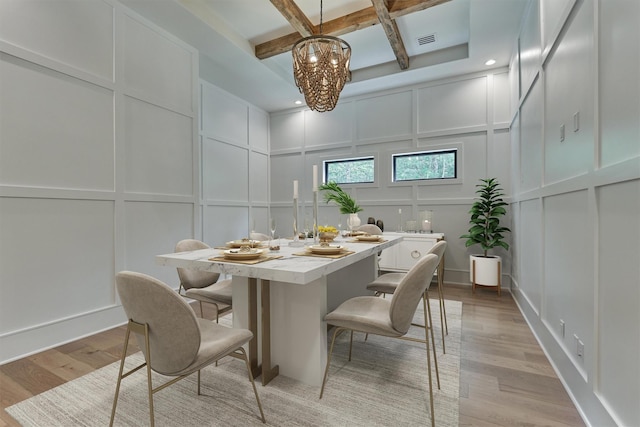 dining room featuring beam ceiling, light hardwood / wood-style flooring, and coffered ceiling